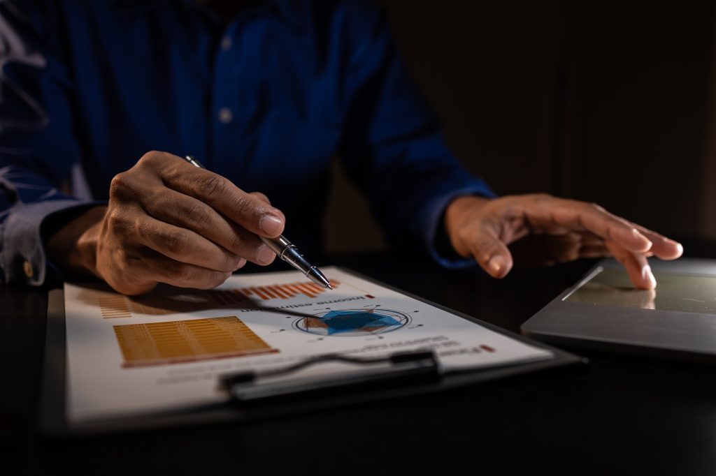 a businessman works overtime is his accounting firm's office until late at night